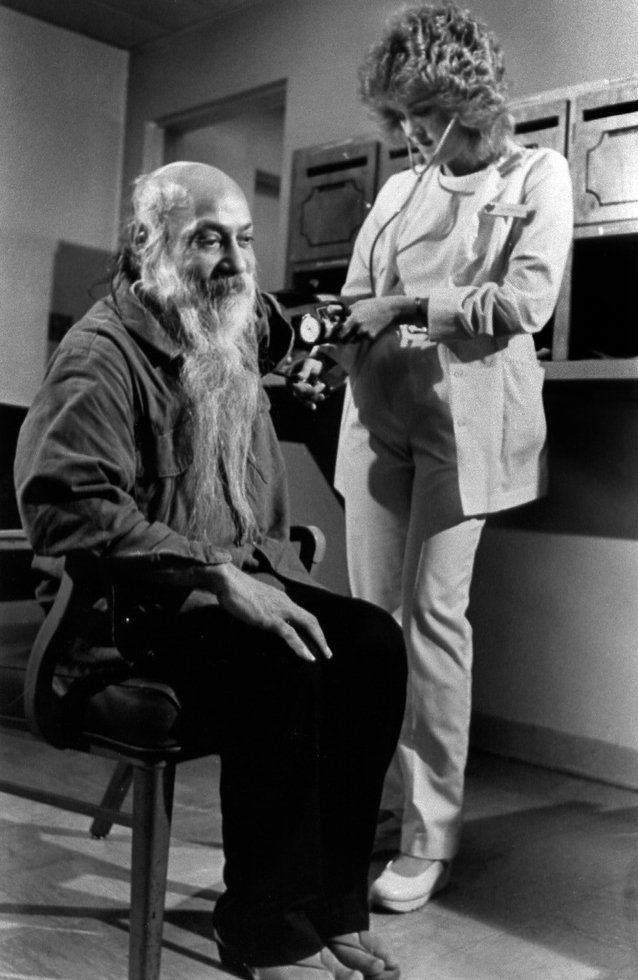 A nurse checks on Osho in custody in North Carolina, 1985
