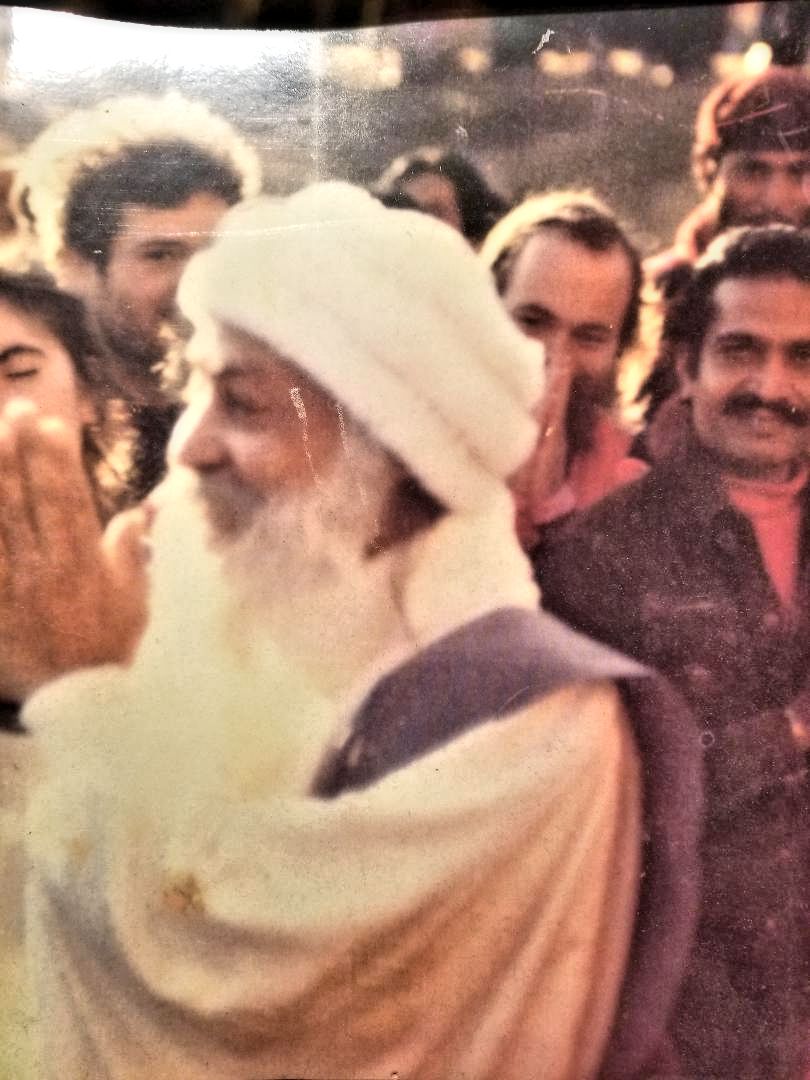 Osho in Kathmandu, February 1986, with the author standing behind him