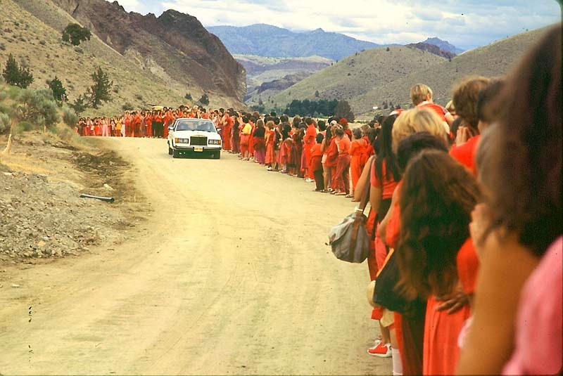Disciples lining the road for Osho's daily drive-by at Rajneeshpuram